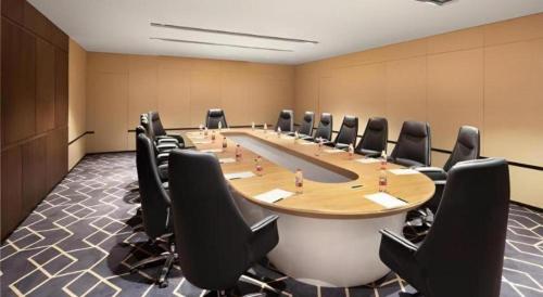 a large conference room with a long table and chairs at Echarm Hotel Shenyang Zhongjie North Station Metro Station in Shenyang
