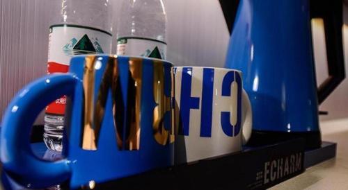 a group of coffee mugs with the word fico on them at Echarm Hotel Kunming High-speed Railway South Station Chunrong Street Metro Station in Kunming