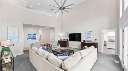 a living room with a couch and a tv at Lake Escape by AvantStay Lakefront Private Dock in Mooresville