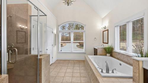 a large bathroom with a tub and a shower at Lake Escape by AvantStay Lakefront Private Dock in Mooresville
