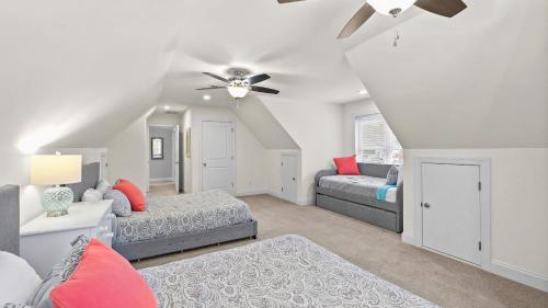 a bedroom with two beds and a ceiling fan at Lake Escape by AvantStay Lakefront Private Dock in Mooresville