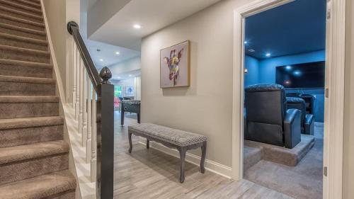 a hallway with stairs and a chair and a stair case at Lake Escape by AvantStay Lakefront Private Dock in Mooresville