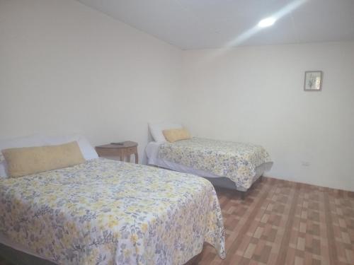 a room with two beds in a room at Cabañas La China in El Congo