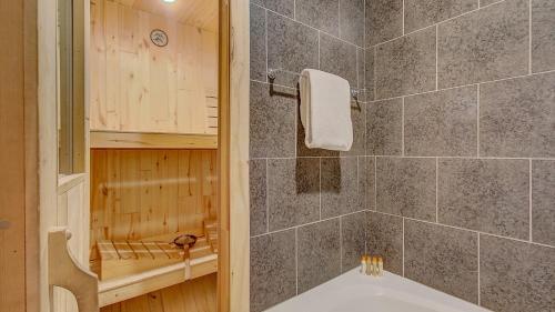 a bathroom with a tub and a shower stall with a tub at Quittin Time Townhouse Peaceful Mountain Ski-In-Ski-Out Retreat Close to Town in Park City