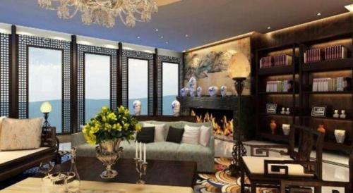 a living room with a couch and a fireplace at Balan International Hotel in Dujiangyan
