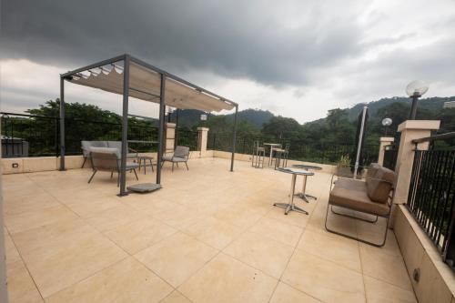 a patio with chairs and a table on a roof at Residence MASSOU in Yaoundé