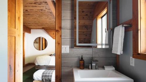 a bathroom with a sink and a mirror at Timberline by AvantStay Stunning Chalet Cabin w Hot Tub Pool Table Home Theater in Tahoe Vista