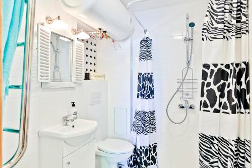 a bathroom with a shower and a toilet and a sink at Heart of Kalamaja Apartment in Tallinn