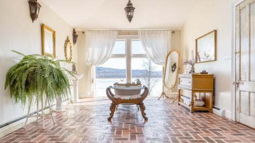 a foyer with a table and a large window at River House by AvantStay Historic Secluded Estate on the Hudson River w Pool Sleeps 24 in Hudson