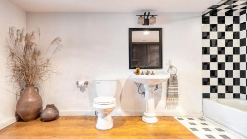 a bathroom with a white toilet and a sink at River House by AvantStay Historic Secluded Estate on the Hudson River w Pool Sleeps 24 in Hudson