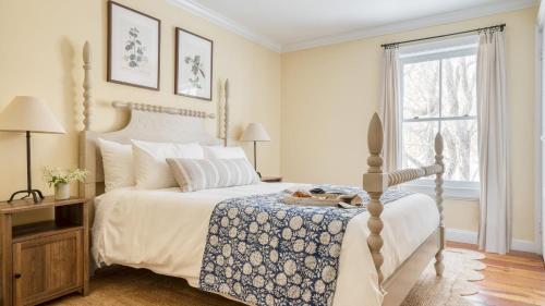 a bedroom with a bed and a window at River House by AvantStay Historic Secluded Estate on the Hudson River w Pool Sleeps 24 in Hudson