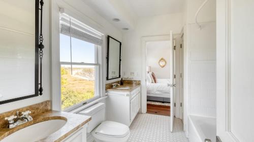 a bathroom with a sink and a toilet and a tub at Haven by AvantStay Luxury Beachfront Home w Pool Gorgeous Patios in Sullivans Island