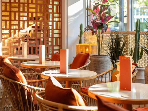 a row of tables and chairs in a restaurant at Novotel Luxembourg Kirchberg in Luxembourg