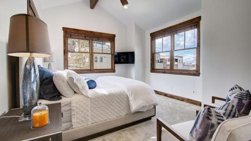 ein Schlafzimmer mit einem Bett und zwei Fenstern in der Unterkunft Main Street Escape by AvantStay Stunning Home right off Main Street w Hot Tub Large Deck in Park City