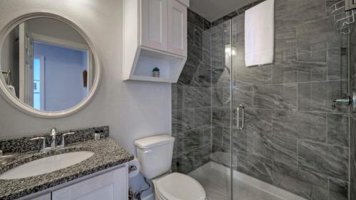 a bathroom with a toilet and a sink and a shower at 6BDR Bay Haven w Shared Waterfront Pool Boat Dock Keeper Trout by AvantStay in Padre Island