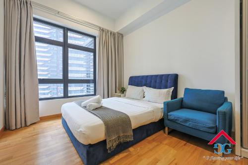 a bedroom with a bed and a blue chair at Astoria Ampang By Grabstay in Kuala Lumpur
