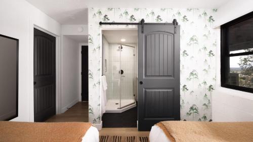 a bathroom with a gray door and a shower at Roca Roja by AvantStay Mountain Views in the Heart of Sedona in Sedona