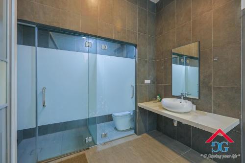 a bathroom with a shower and a sink and a mirror at Astoria Ampang By Grabstay in Kuala Lumpur