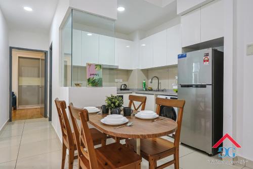a kitchen with a wooden table and a refrigerator at Astoria Ampang By Grabstay in Kuala Lumpur