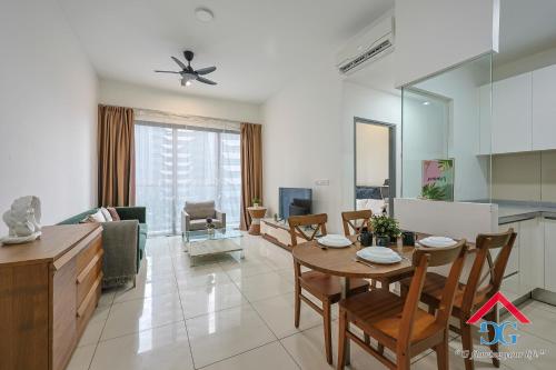 a kitchen and living room with a table and chairs at Astoria Ampang By Grabstay in Kuala Lumpur