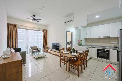 a kitchen and living room with a table and chairs at Astoria Ampang By Grabstay in Kuala Lumpur