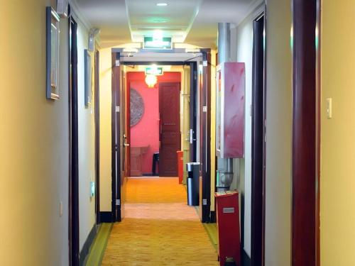 a corridor of a hallway with a long hallway at Green Tree Inn Urumqi San'gong Metro Station Exit in Ürümqi