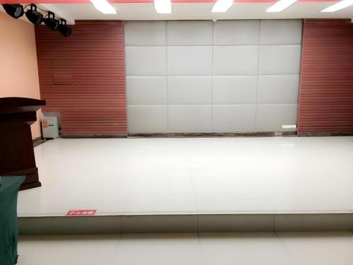an empty gym with white floors and red doors at Green Tree Inn Urumqi San'gong Metro Station Exit in Ürümqi