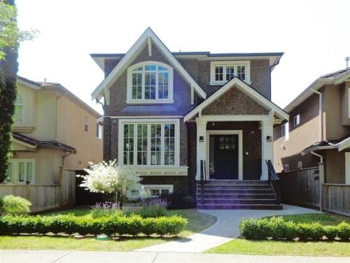 a house with a blue front door and stairs at Cozy Guest Suite in Quiet Home with Private Entry in Vancouver