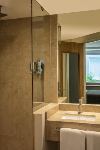 a bathroom with a sink and a mirror at One Ciudad de Mexico La Raza in Mexico City