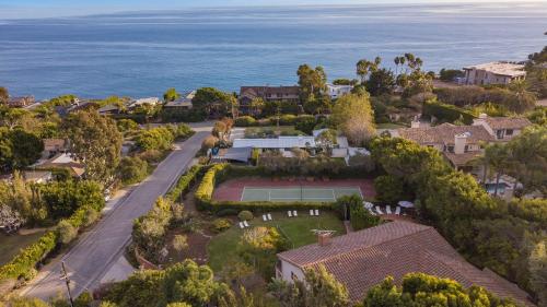 an aerial view of a house with a tennis court at Dume Point by AvantStay Tennis Pool in Malibu in Malibu