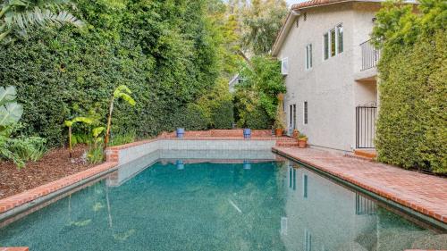 a swimming pool in the backyard of a house at Dume Point by AvantStay Tennis Pool in Malibu in Malibu