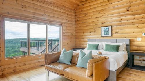 a bedroom with a bed and a couch and a window at Chester by AvantStay Amazing Views Secluded Home A True City Escape in Austerlitz
