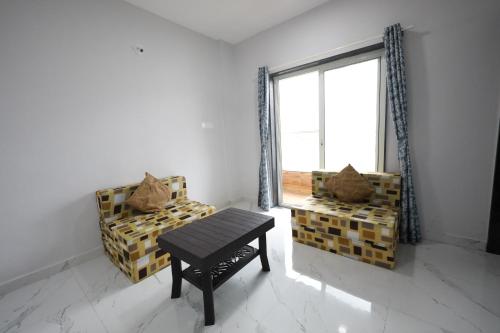 a room with a table and a bench and a window at Azura Vista by Alt Acco in Pune