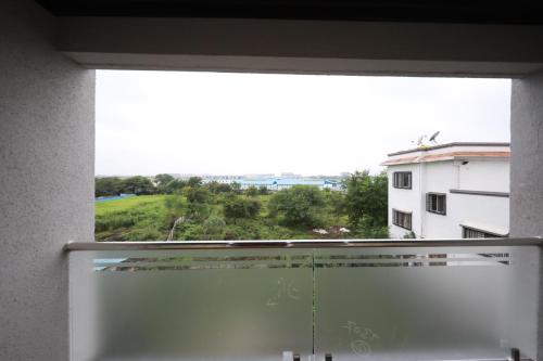 a window with a view of a building at Azura Vista by Alt Acco in Pune