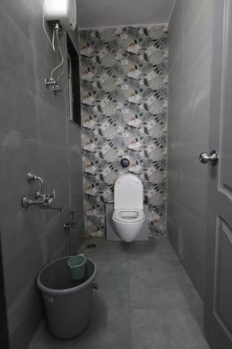 a bathroom with a toilet and a bath tub at Azura Vista by Alt Acco in Pune