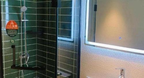 a green tiled shower in a bathroom with a window at GreenTree Inn Luoyang Henan University of Science and Technology in Luoyang
