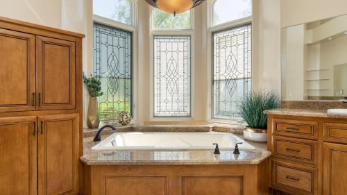 a kitchen with a large sink and two windows at Camila by AvantStay 18-Person Temecula Mansion in Temecula