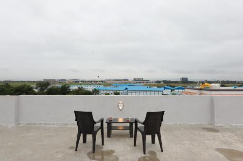a table and two chairs on a roof at Azura Vista by Alt Acco in Pune