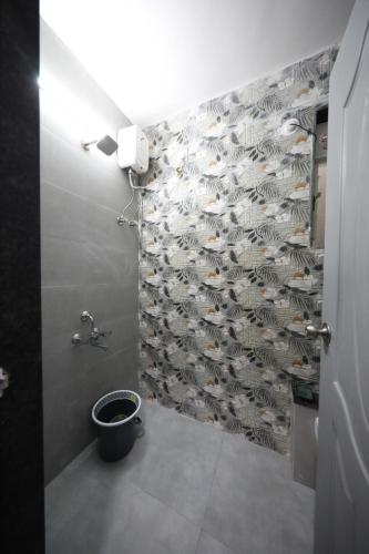 a bathroom with a wall with a bunch of birds on it at Azura Vista by Alt Acco in Pune