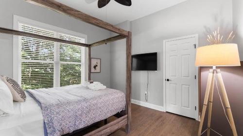 a bedroom with a bed and a window at Laid Back Lake Life by AvantStay Waterfront View in Mooresville