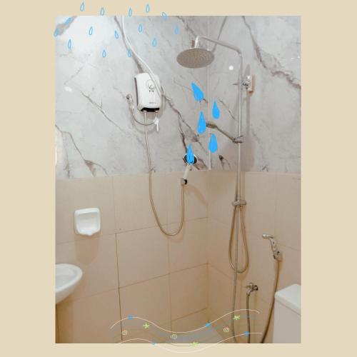 a bathroom with a shower with a shower head at City Nest in Iloilo City