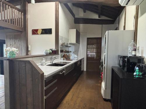 a kitchen with a sink and a refrigerator at 民泊道場 in Kami Amakusa