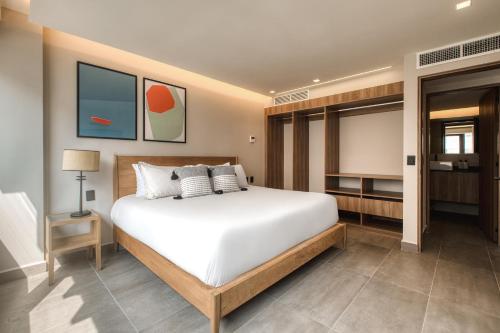 a bedroom with a large white bed in it at Namóra by Lumina in Guadalajara