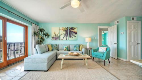 a living room with a couch and a table at Beachfront Complex w 2 Pools Tennis Gulf Views Rise N Beach by AvantStay in Port Aransas