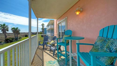 a porch with blue chairs and a table at Beachfront Complex w 2 Pools Tennis Gulf Views Rise N Beach by AvantStay in Port Aransas