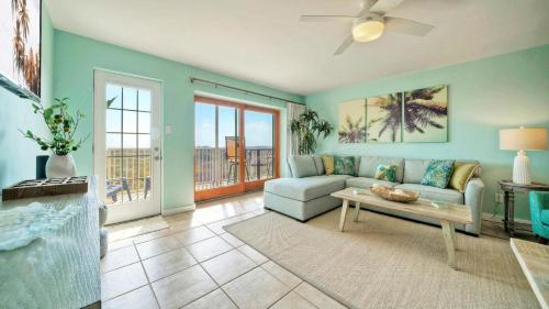 a living room with a couch and a table at Beachfront Complex w 2 Pools Tennis Gulf Views Rise N Beach by AvantStay in Port Aransas