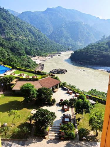 a view of a river with mountains in the background at Aloha Apartments by blissful Ganges in Rishīkesh