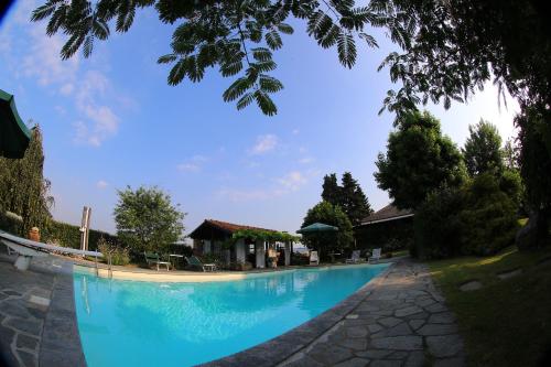 a large blue swimming pool in a resort at Le Soleil in Vigone