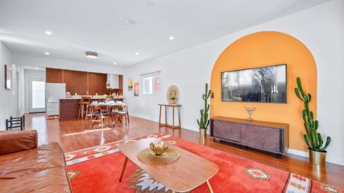 a living room with a couch and a table at Southwest by AvantStay Heart of Hollywood Remodeled 1920s Bungalow in Los Angeles