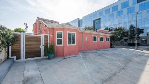 a small red building in front of a building at Southwest by AvantStay Heart of Hollywood Remodeled 1920s Bungalow in Los Angeles